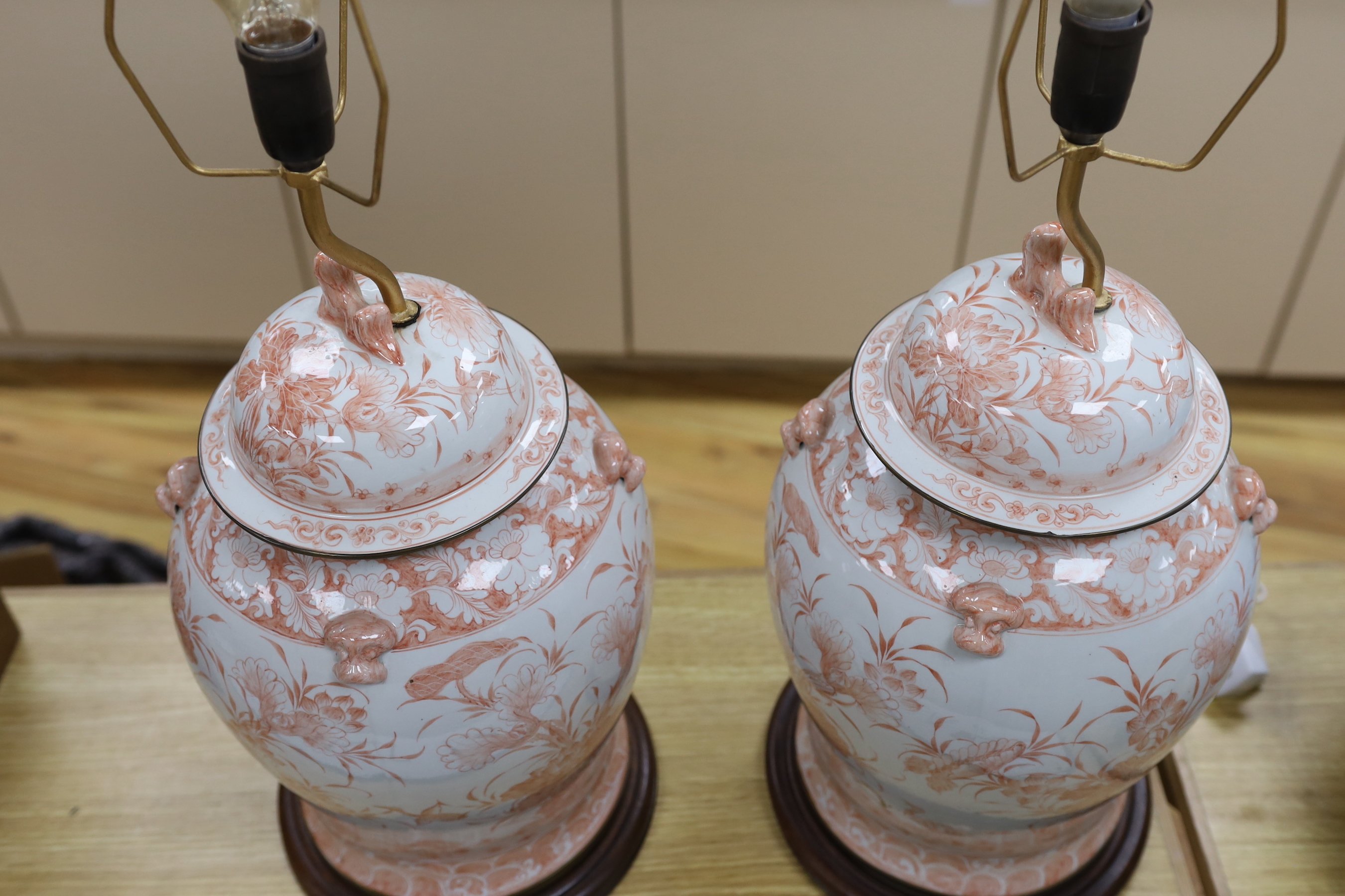 A pair of Chinese style iron red porcelain table lamps